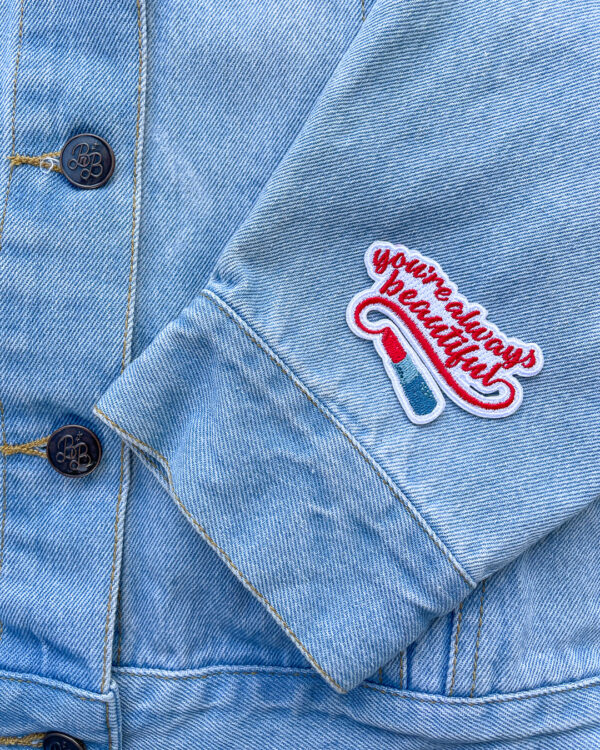 One embroidered patch inspired by Sally Thorne's "The Hating Game" that says "you're always beautiful" with red lipstick.